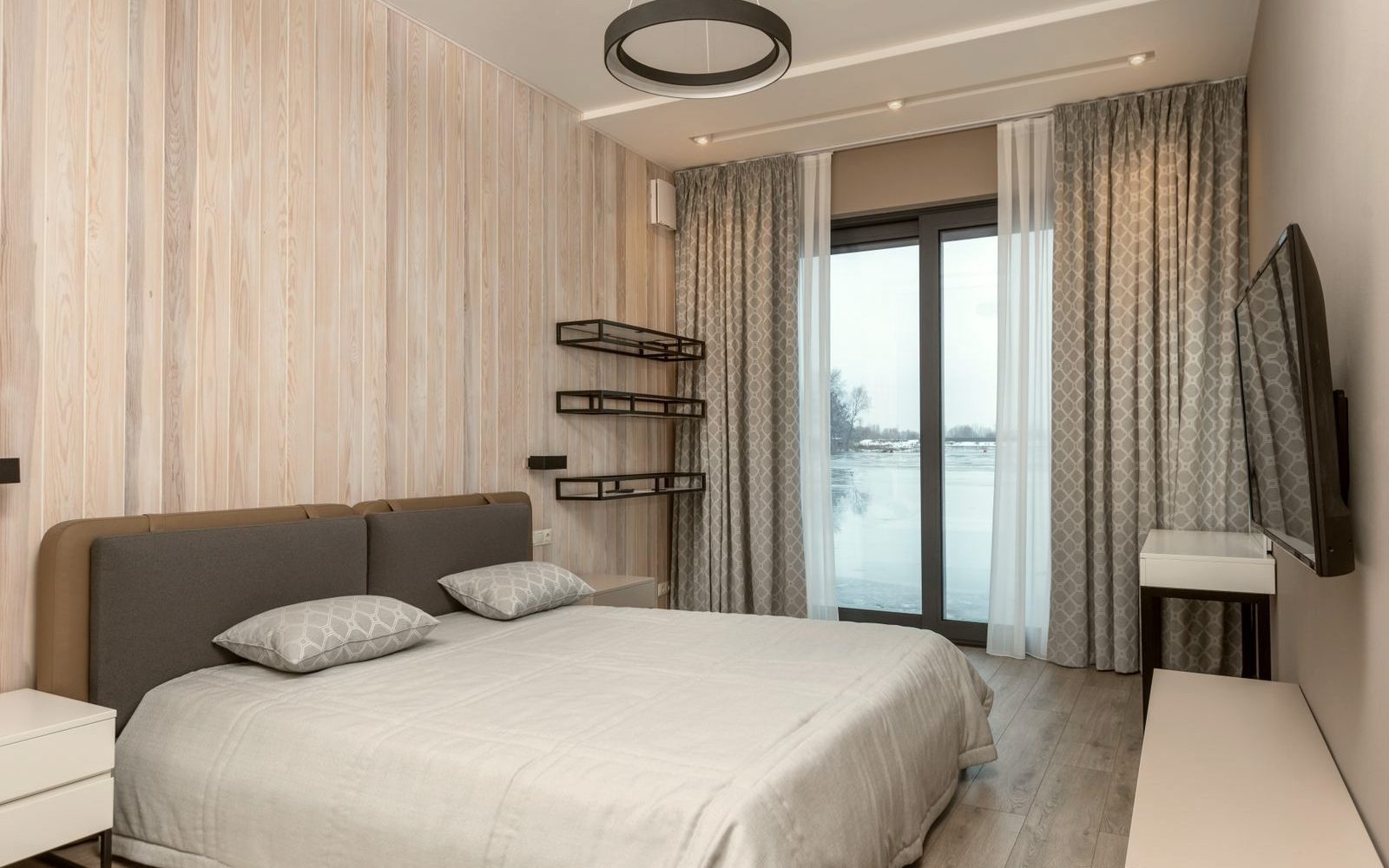 Bedroom with a motorised roller blind closing at dusk